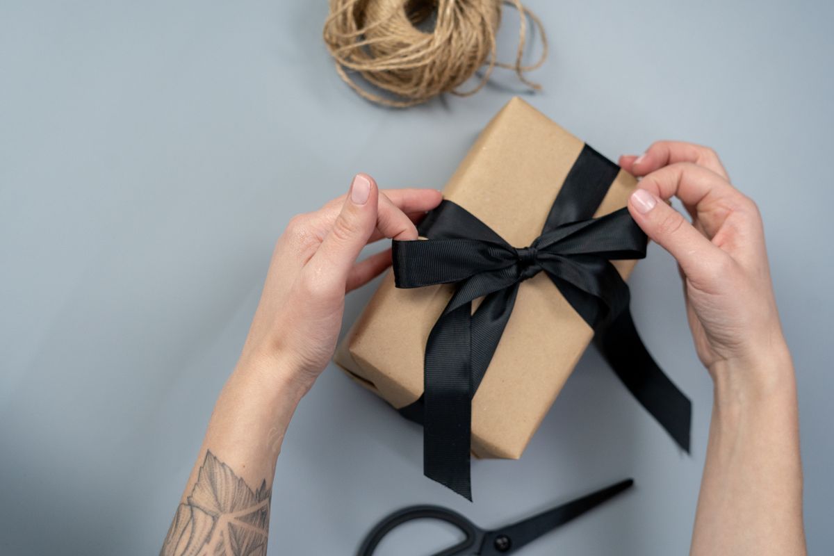 Corporate gift being wrapped with ribbon