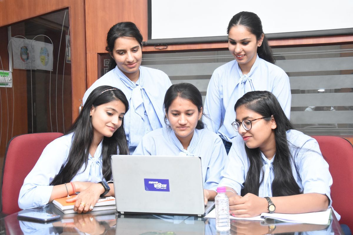 Office team working together at a laptop